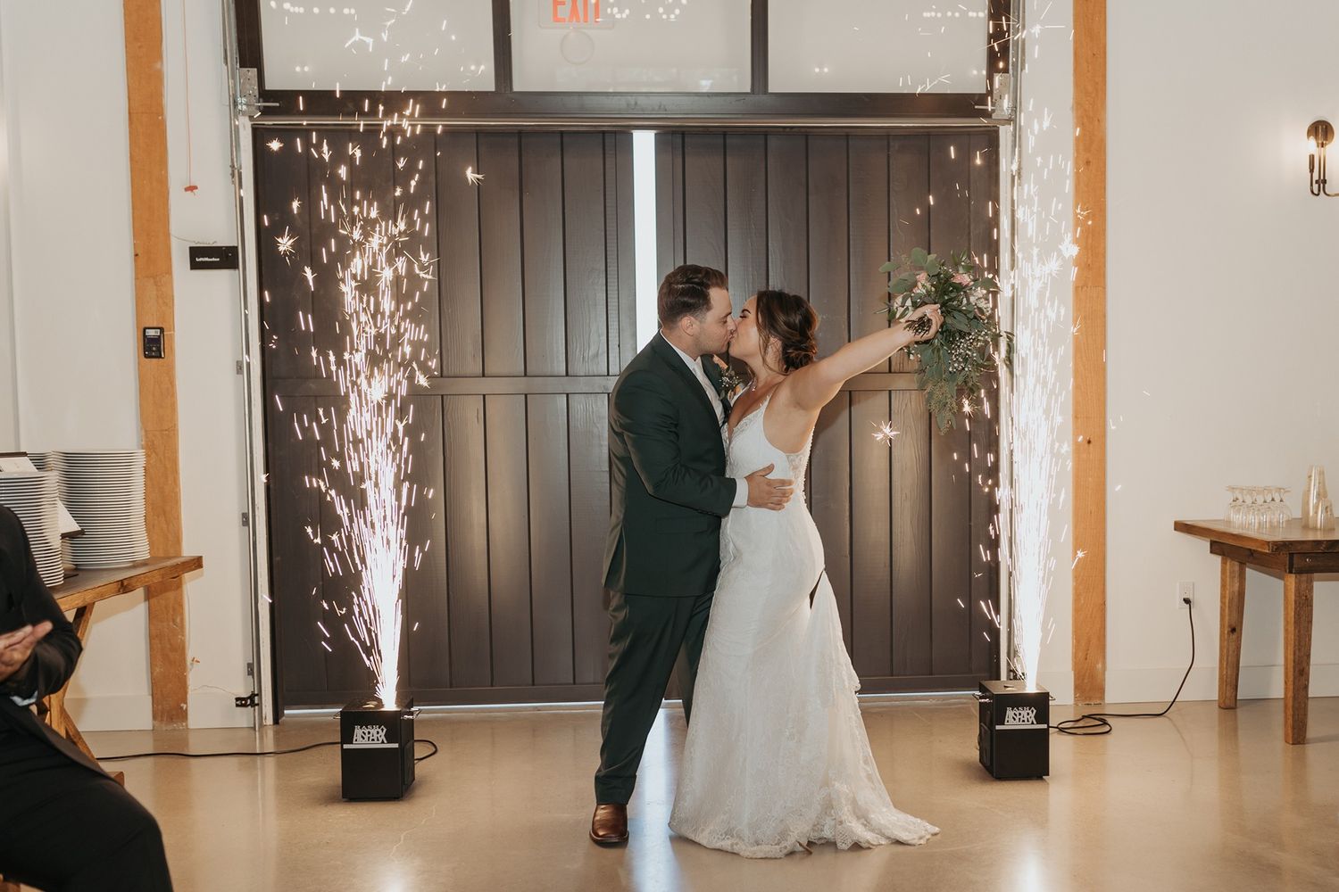 A couple enters their wedding reception with sparklers illuminating the elegant venue Canopy Grove by Wedgewood Weddings.