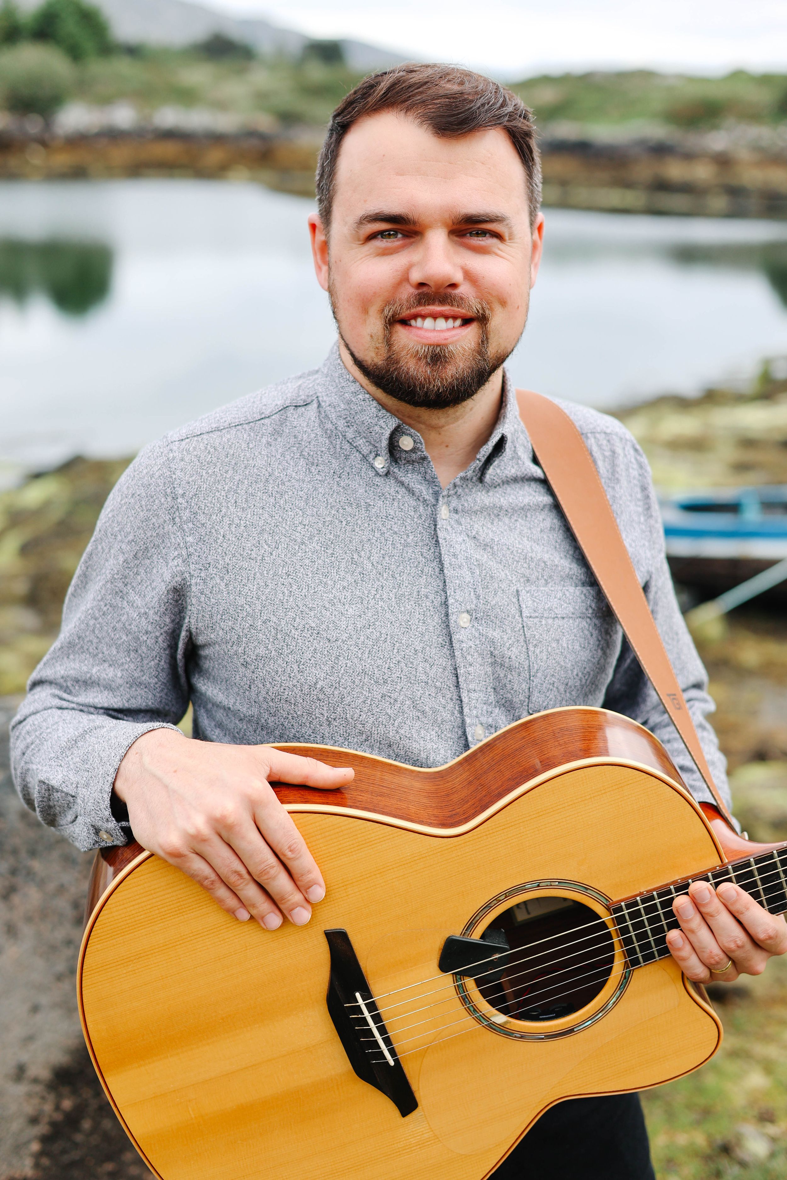 Branding photo of guitarist with instrument.