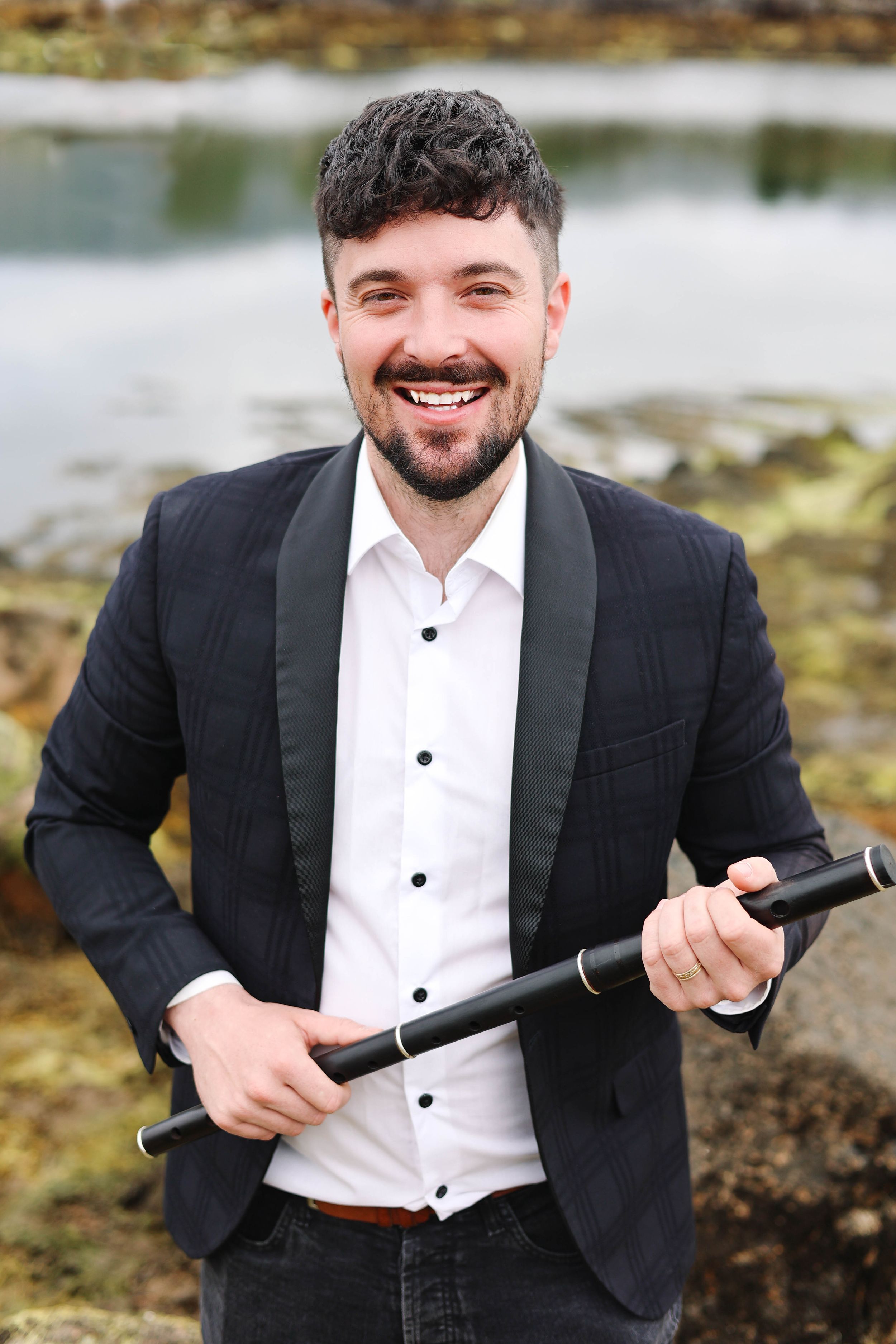 Branding photo of flute player with instrument.