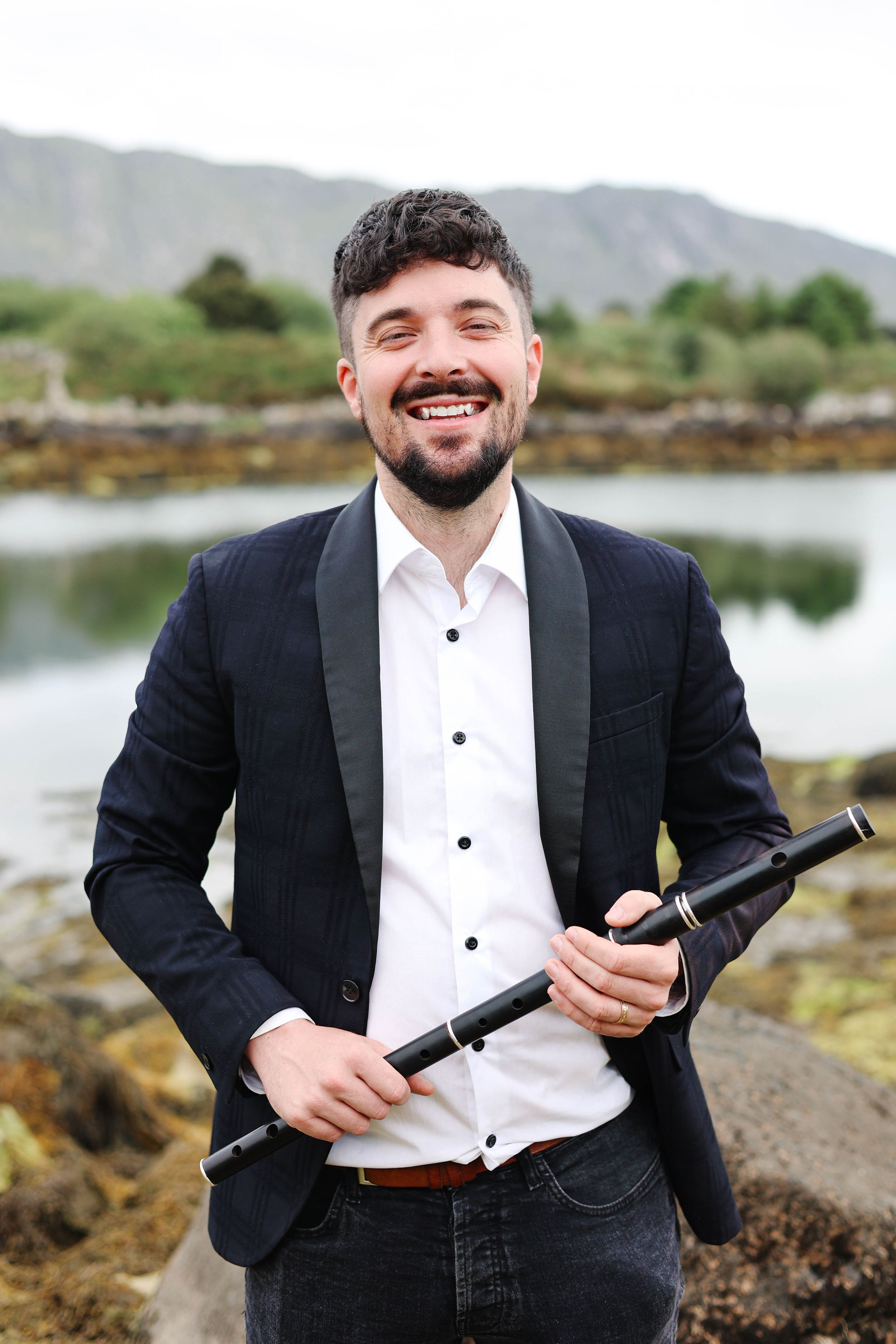 Branding photo of flute player with instrument.