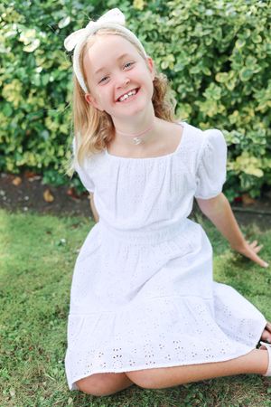Posed picture of young girl laughing in the park.