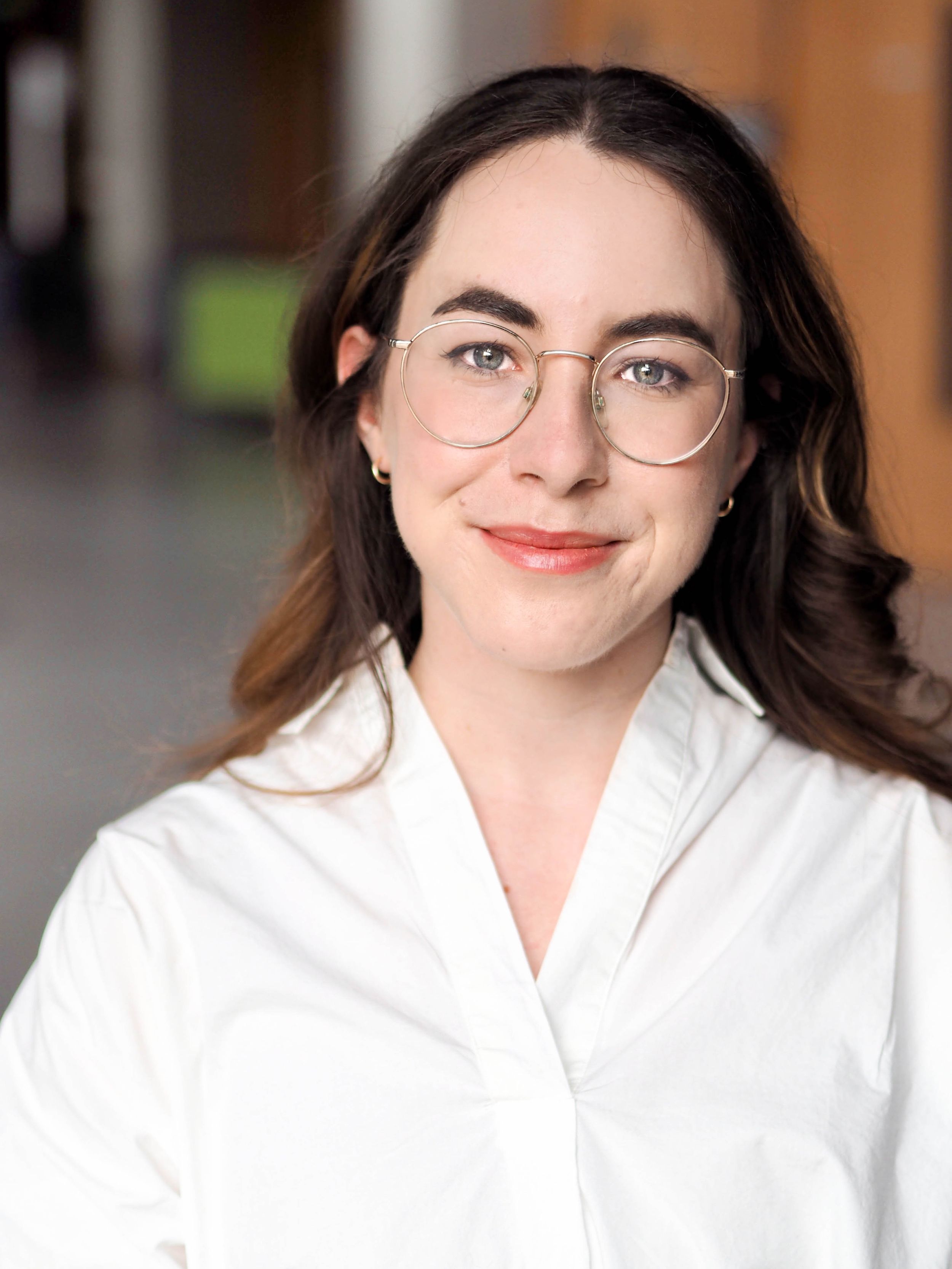 Professional headshot of young woman in academic building.
