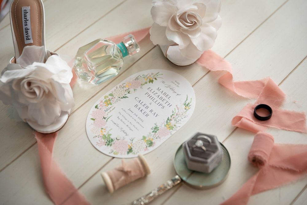 Wedding layflat details laid on a wooden table.