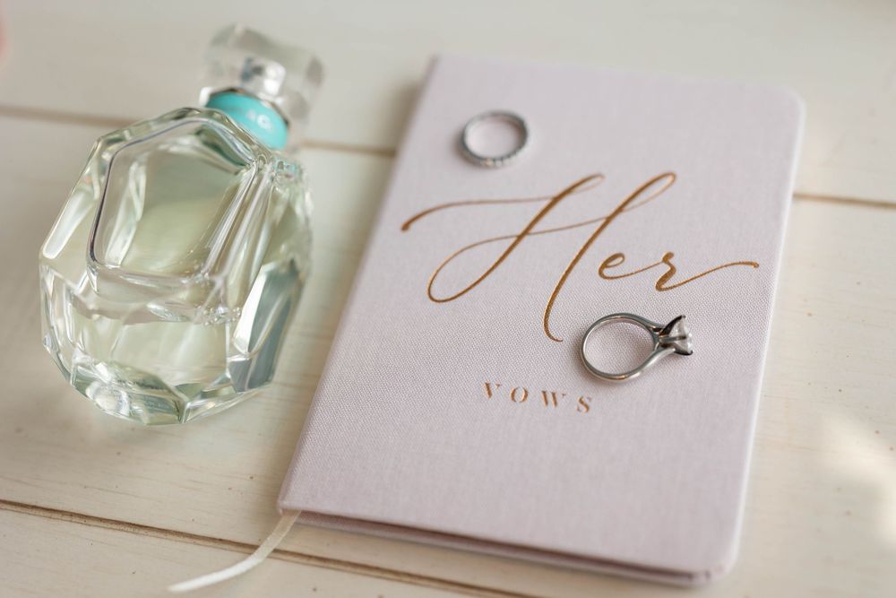 The brides vow book and rings with her perfume