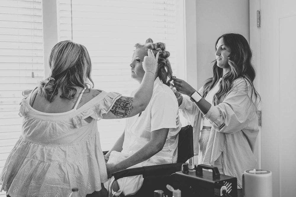 A series of black and white photos showing wedding day preparation moments with people getting ready.