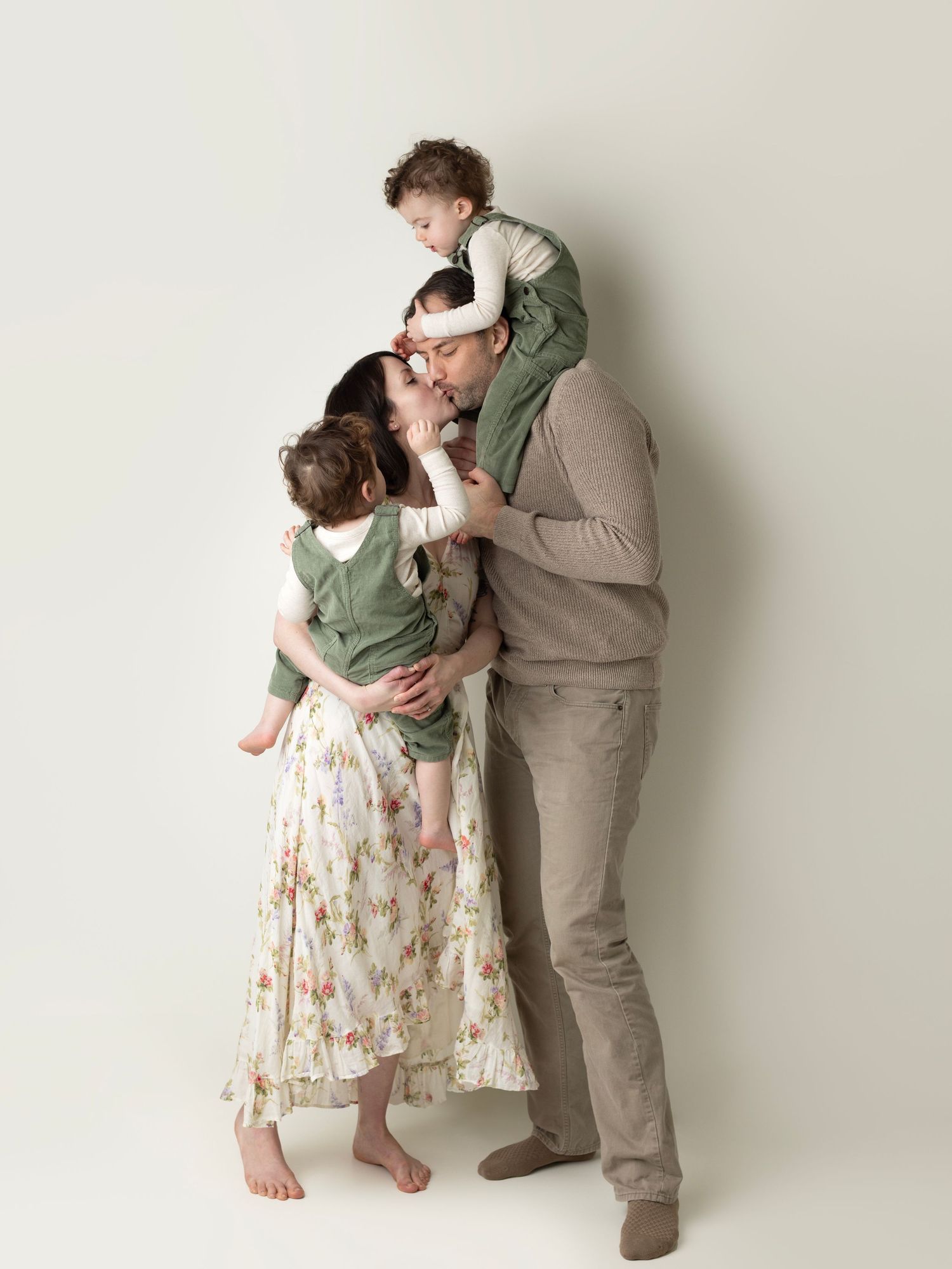 A series of four progressive dance poses showing two people in coordinated green and beige outfits against a white backdrop.