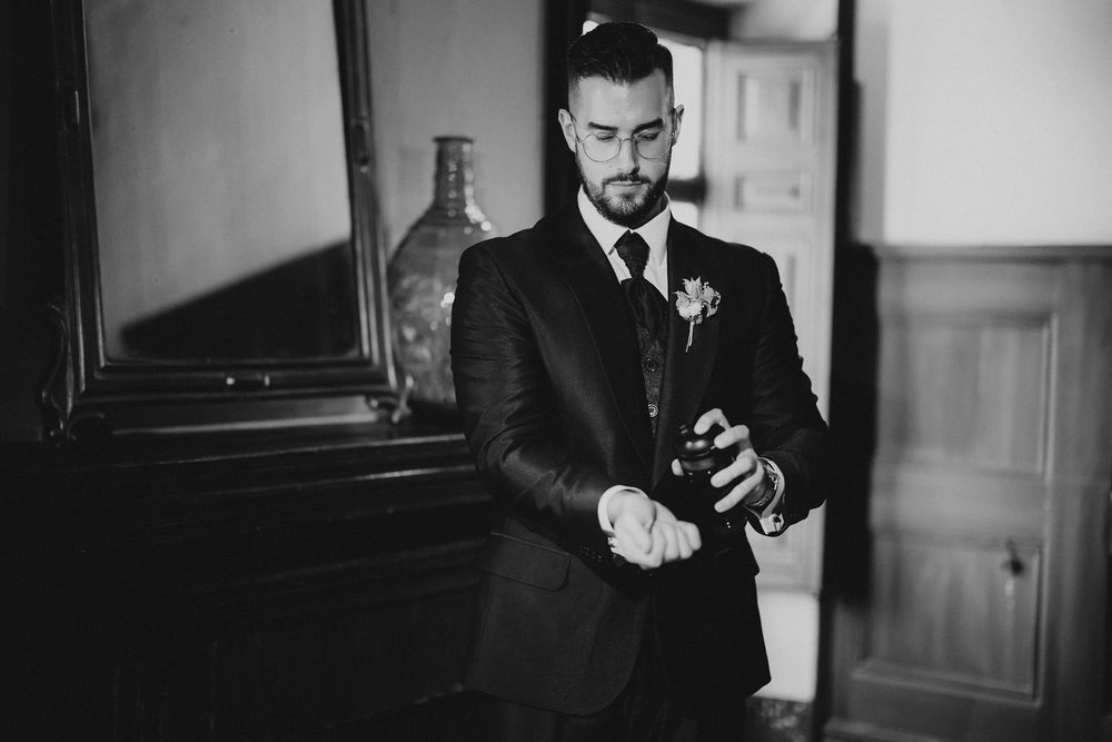 A black and white photo montage showing three views of a man in formal attire checking his mobile phone.