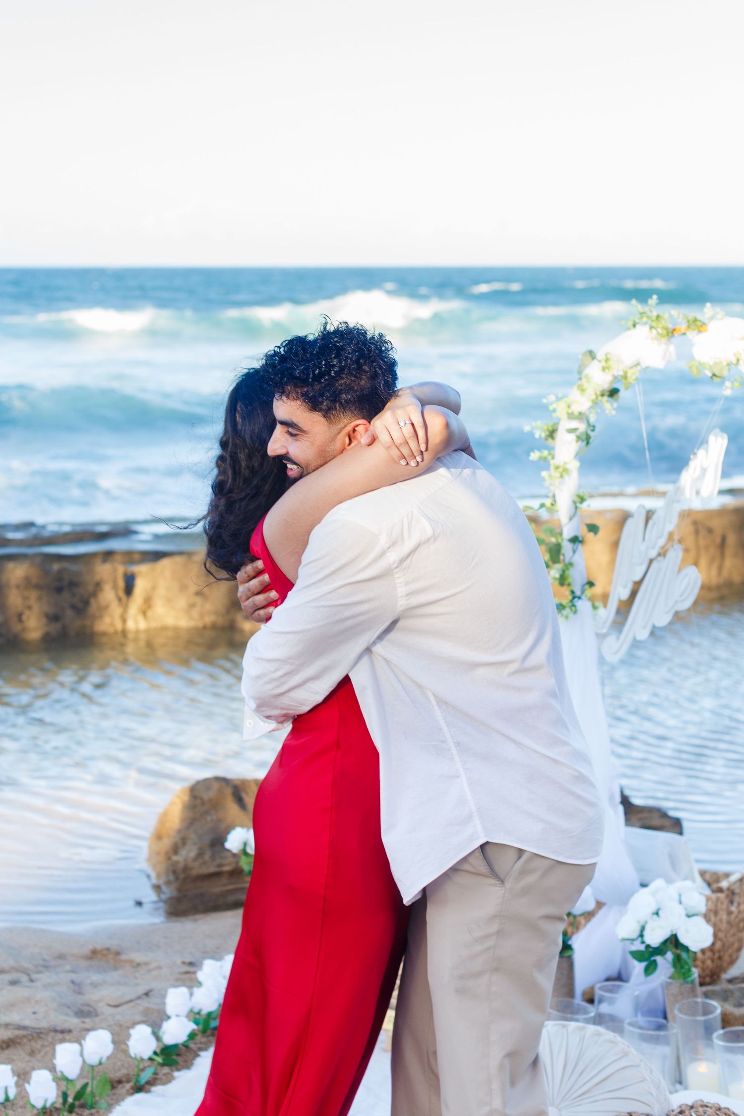 Couples portrait. Proposal and engagement session. Man and woman on the beach hugging. Kikita Surf Beach, Dorado, Puerto Rico.