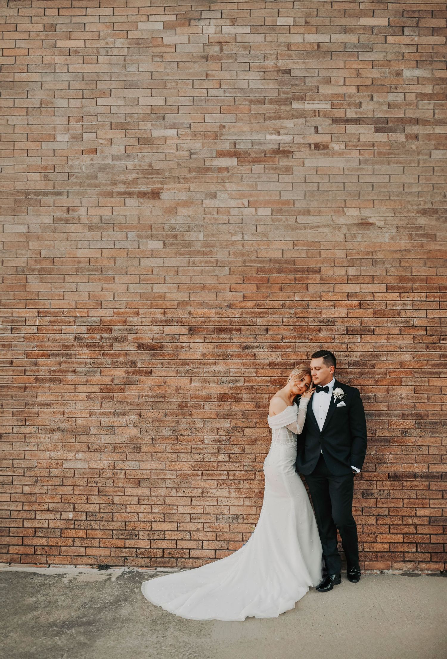 Newlyweds embracing during elegant wedding portraits