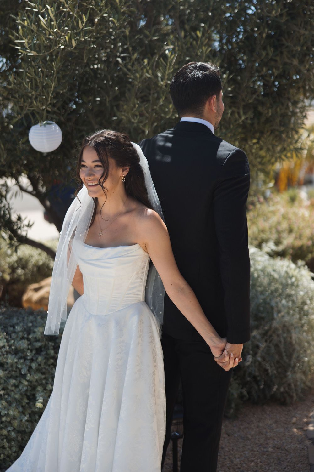 First touch moment between bride and groom before their Ventura wedding