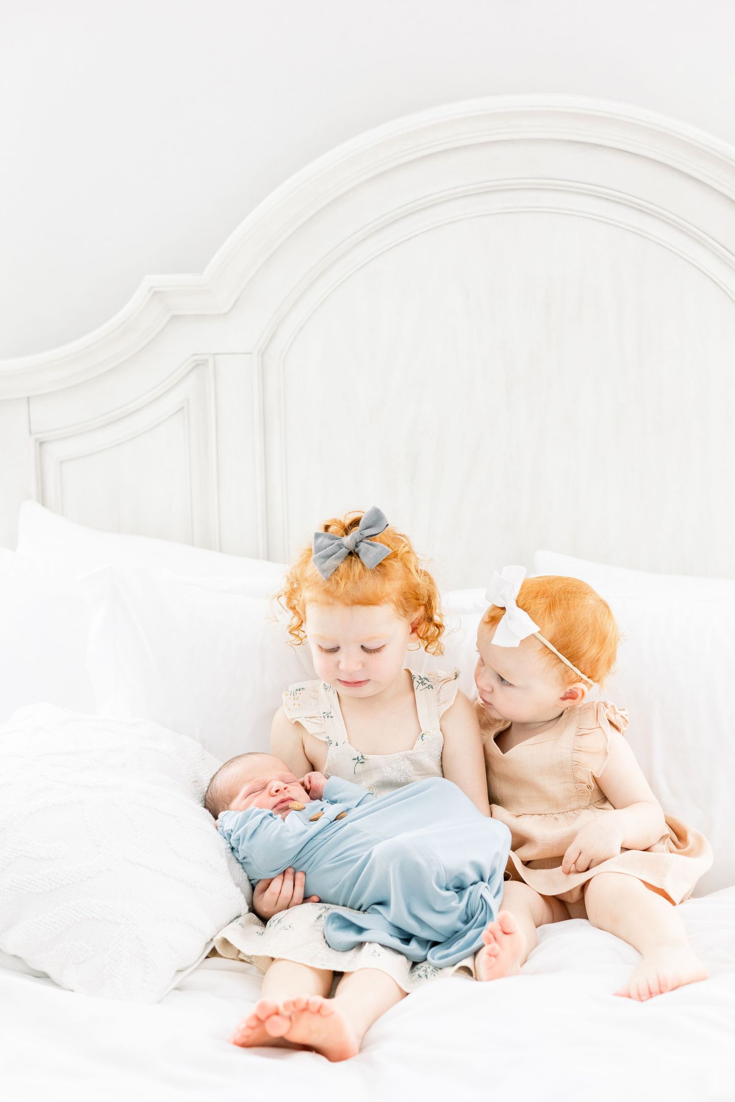 Sibling interacting with newborn during in-home session in Aiken