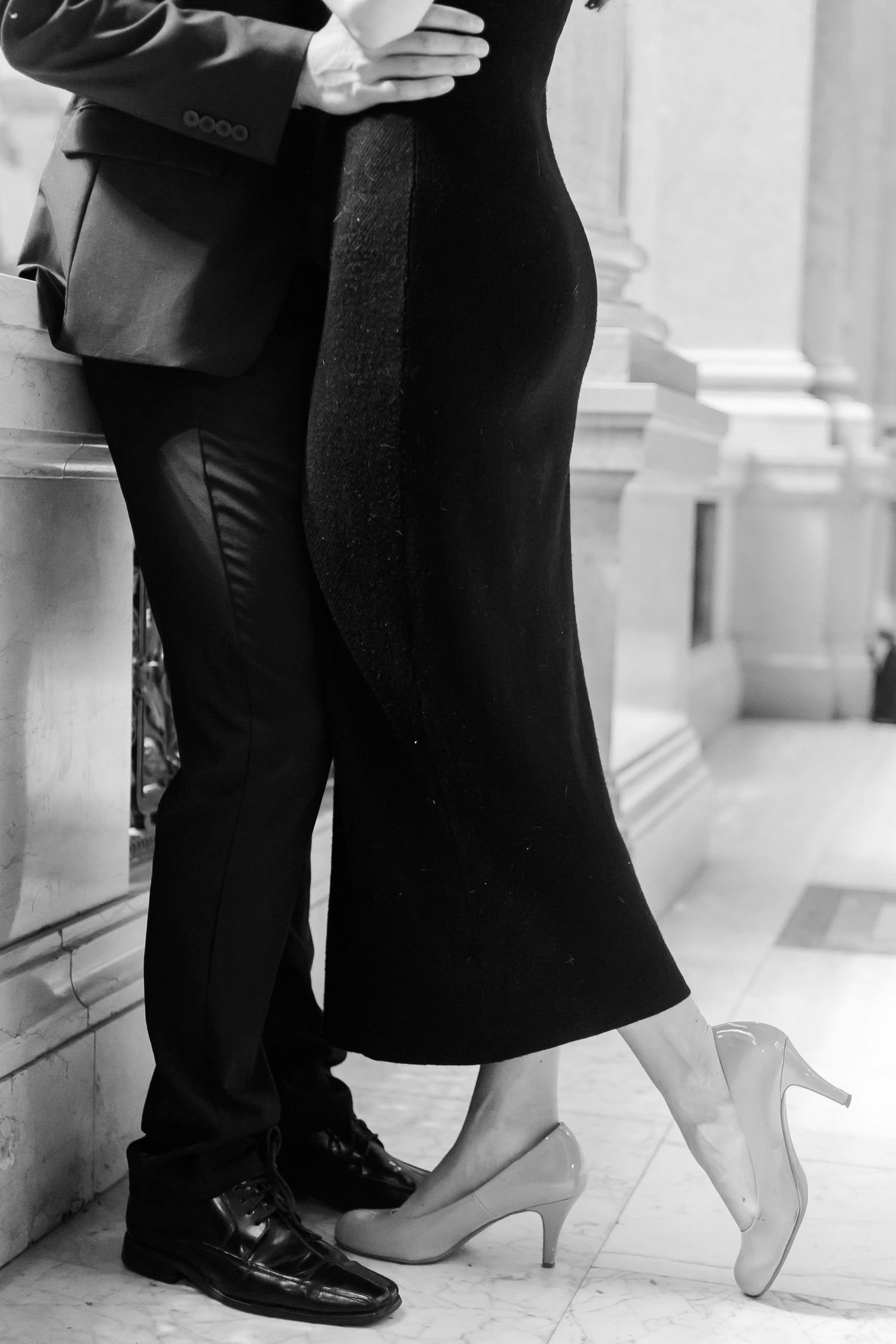 An intimate dance captured in black and white in an elegant interior setting.