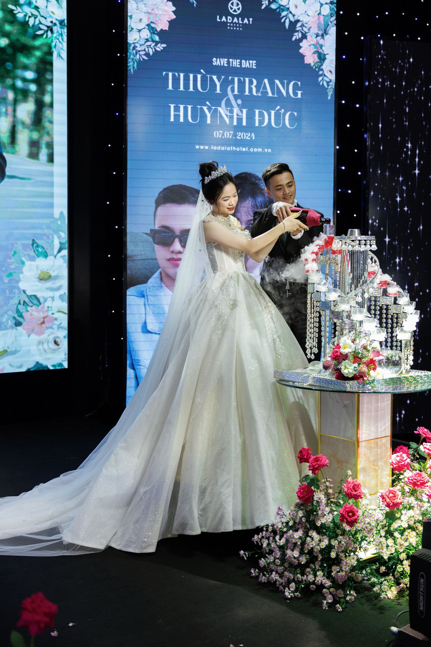 Wedding celebration scene with floral decor and champagne tower.