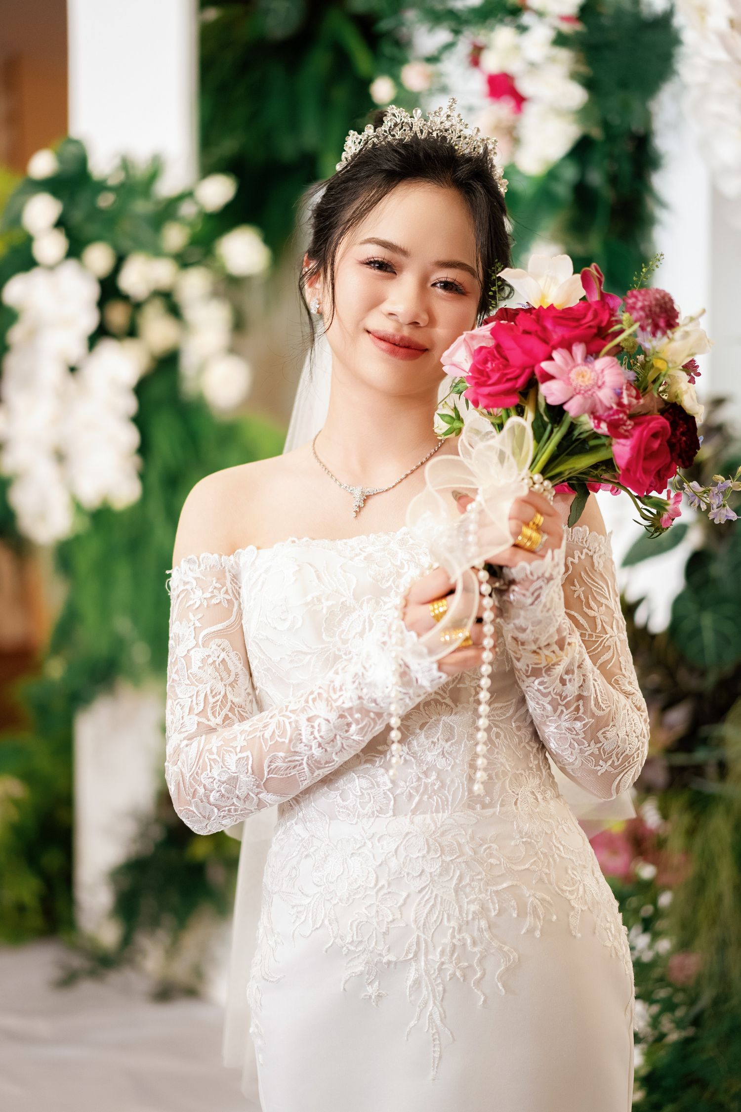 Wedding portrait with lace dress and pink floral bouquet.