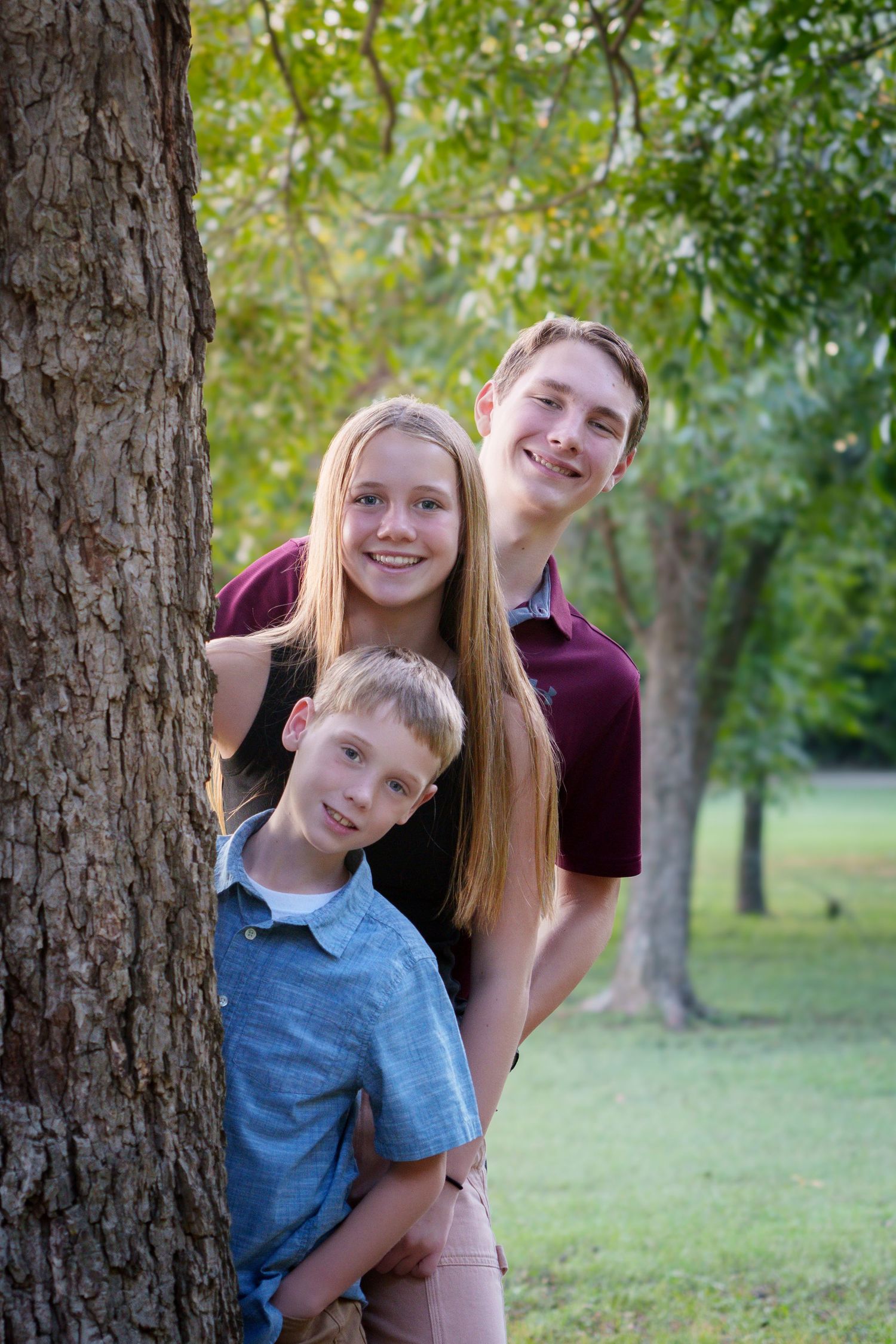 fall family photoshoot Keller Tx portraits sunset Texan hat boots 3 siblings creative pose family outfits outdoors park green field