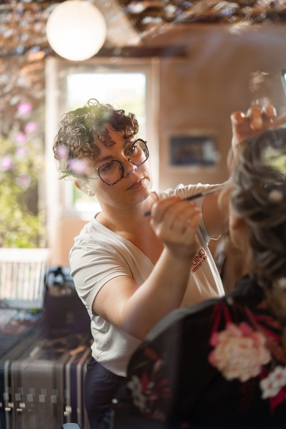 Someone wearing glasses and a white top is lifting a drink to their mouth in a series of repeated photos.
