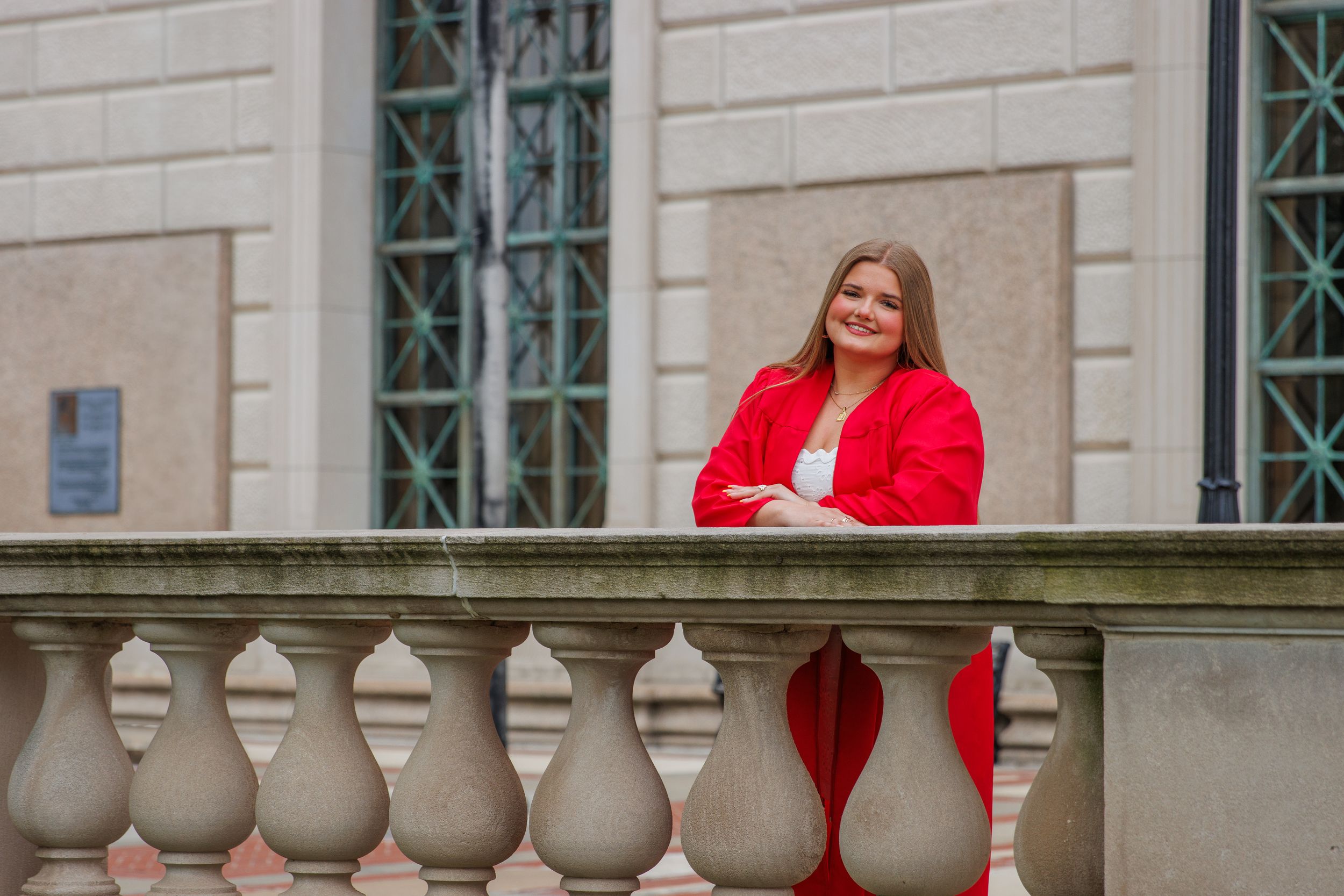 Classic stone architecture with white columns and balustrades captured in multiple angles. Senior girl posed in cap and gown.