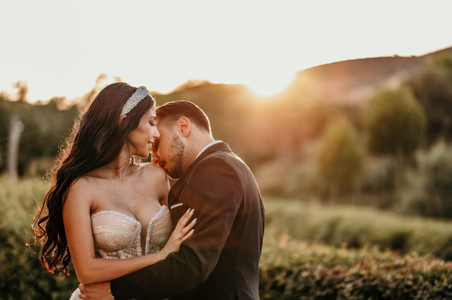 Couple sharing romantic sunset moments in golden light with scenic outdoor landscapes in five sequential images.