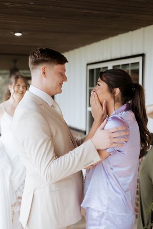 Two lovers embrace in a tender first look moment before their wedding ceremony, captured in multiple frames.