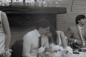 Guests enjoying a casual wedding reception gathering with table settings in black and white.