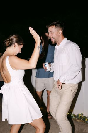 A sequence of photographs showing two people dancing together at night, with one person wearing white and another in khaki.
