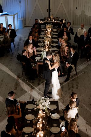Aerial view of bride and groom sharing first dance at candlelit wedding reception.