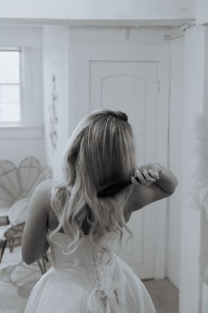 A series of artistic black and white portraits showing movement and emotion in a white room.