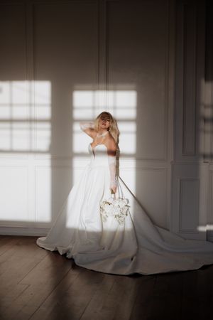 A series of artistic bridal portraits showing movement and flowing white dress against window light in an elegant room.