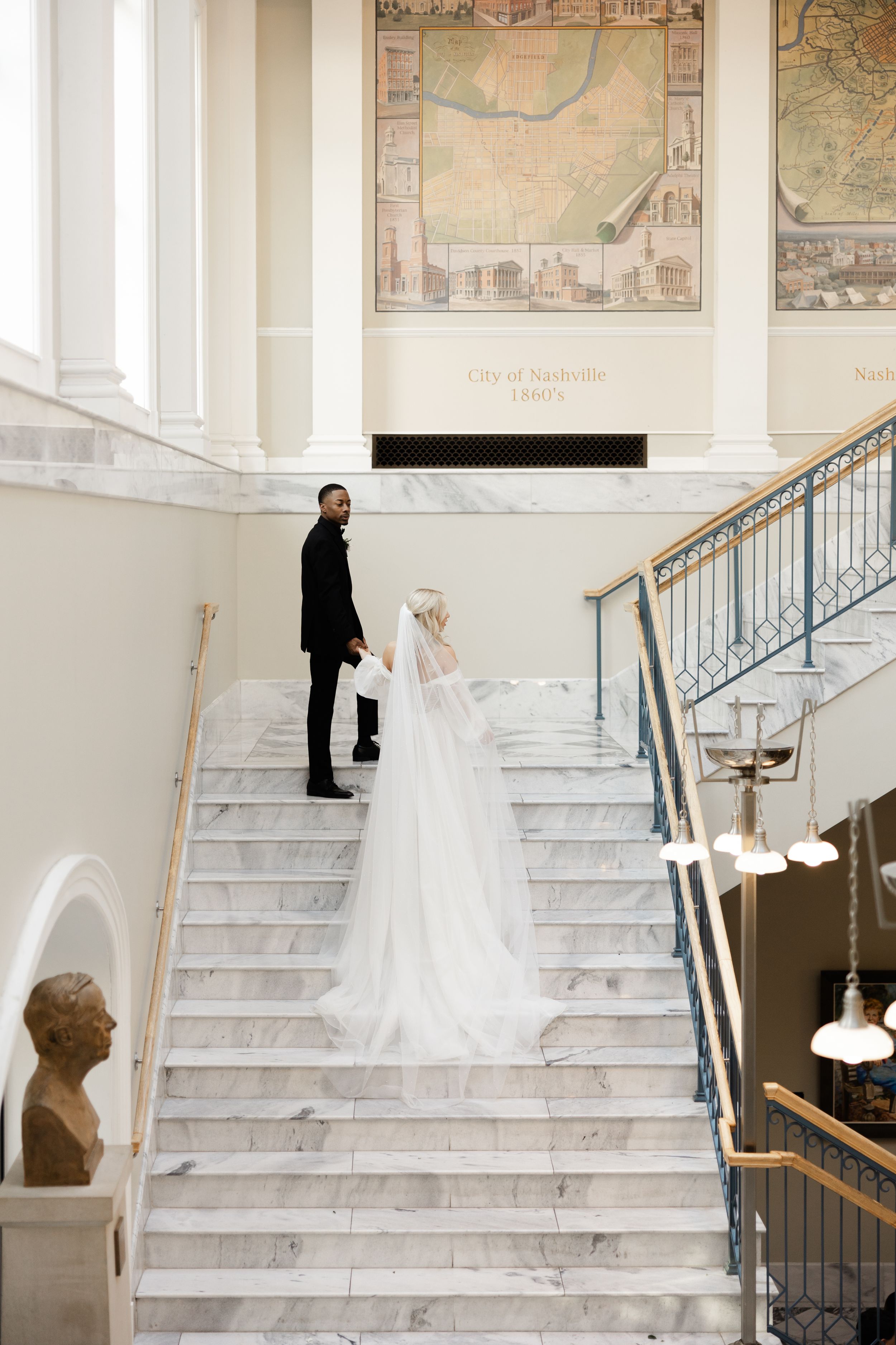 A sequence of photos showing a bride in a white gown walking up elegant marble stairs with vintage maps on the wall.