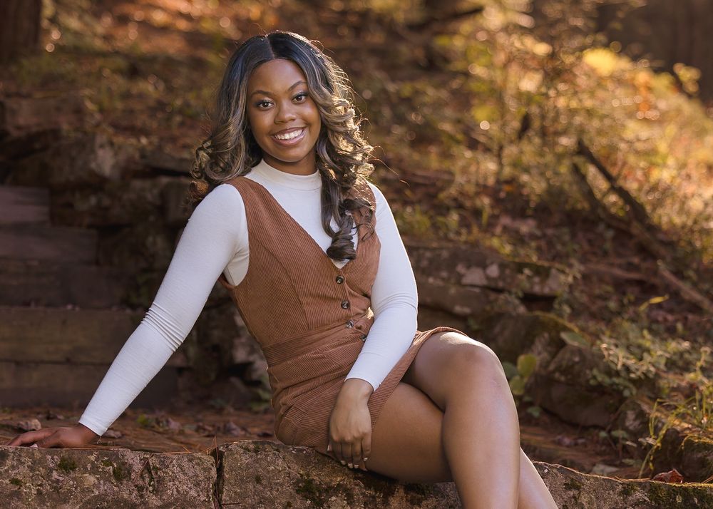 Autumn outdoor photos featuring brown and white outfit against rustic red rock backdrop.