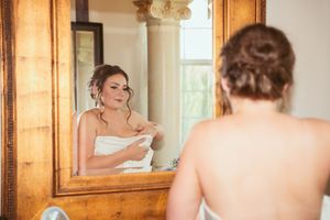 A collage of wedding day preparation scenes from an elegant room with golden mirrors and warm lighting.
