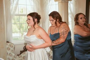 Wedding preparation moments captured in a series of candid shots with white and blue dresses.