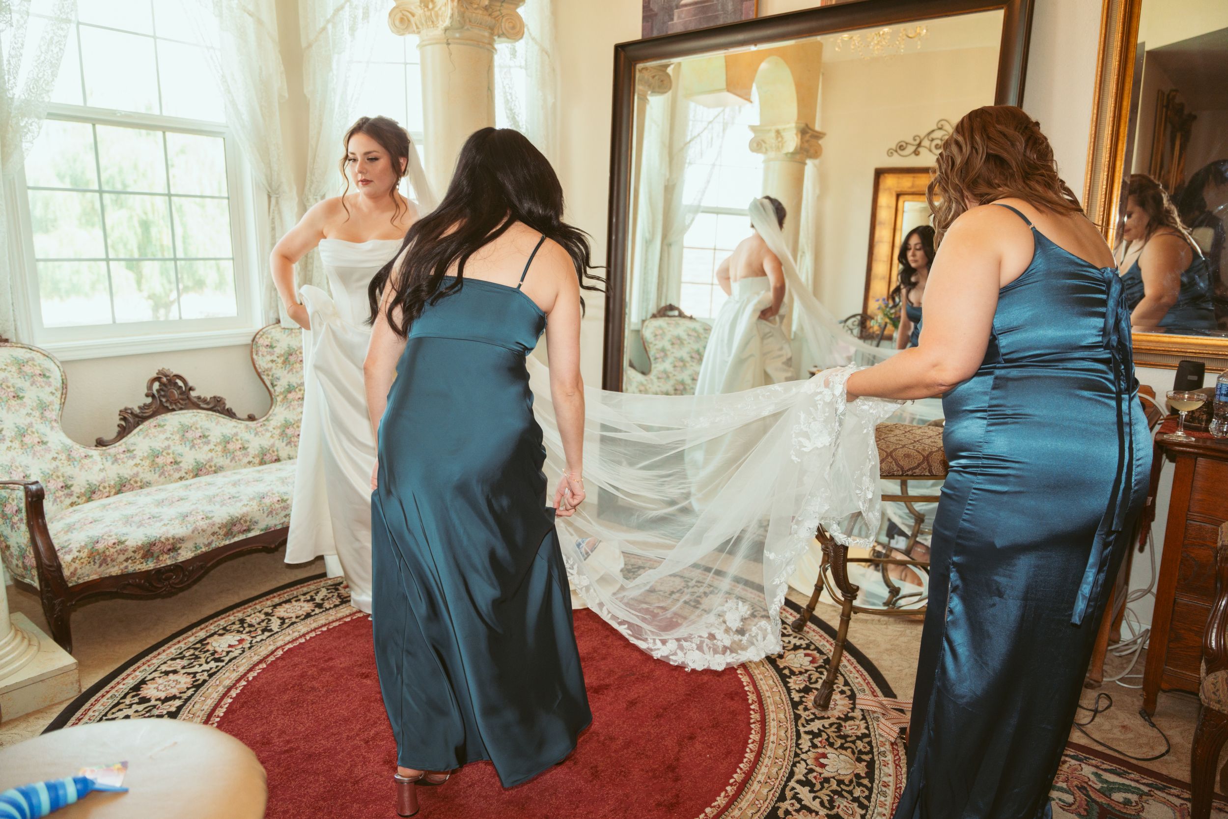 Wedding dress preparation scene in an elegant room with classic decor and natural lighting.
