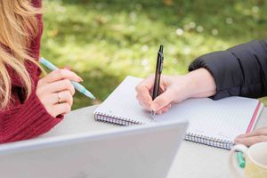 tow women working together on a written document