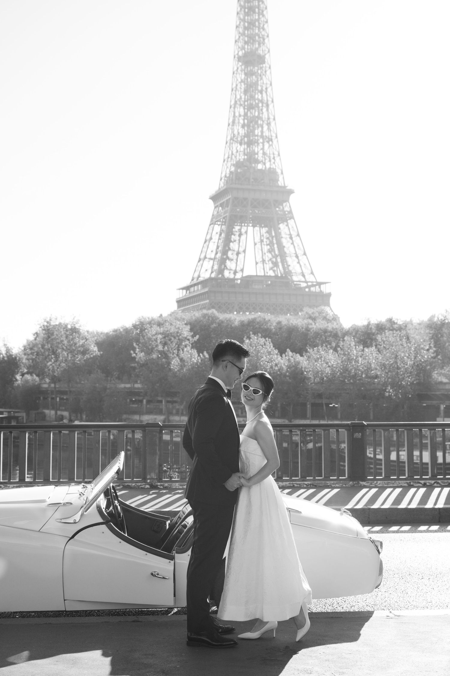 A black and white photo sequence of a couple on a Paris street with the Eiffel Tower visible in the background.