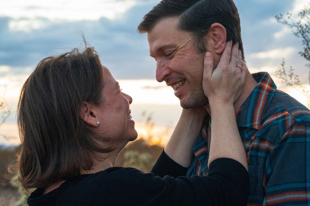 A series of intimate profile photos of a romantic couple embracing against a cloudy sky at sunset. Arizona couples session mountains