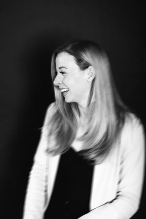 A sequence of black and white artistic portraits showing dynamic movement and laughter in profile view.