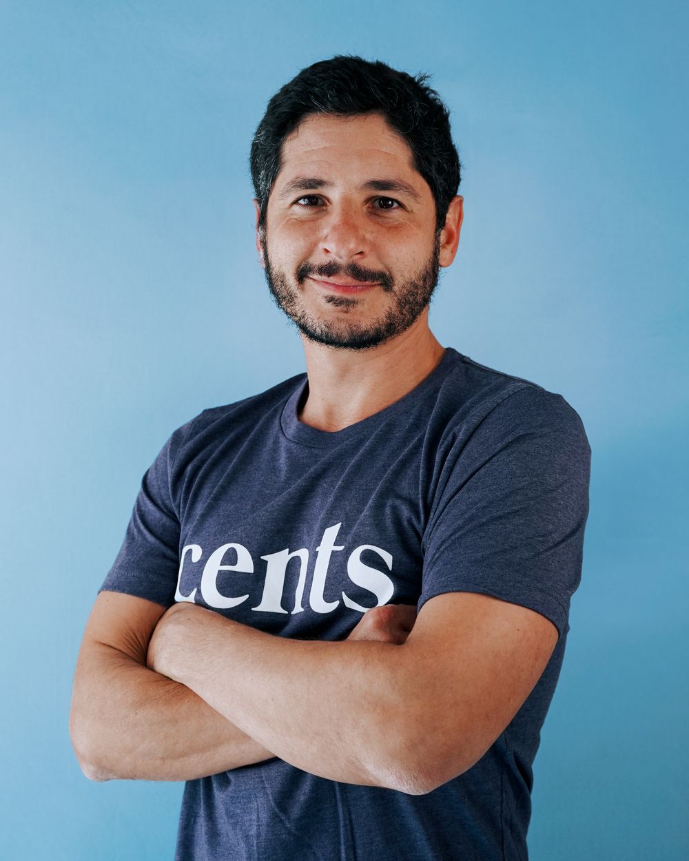 Multiple angles of someone wearing a dark t-shirt with 'cents' branding against blue background.
