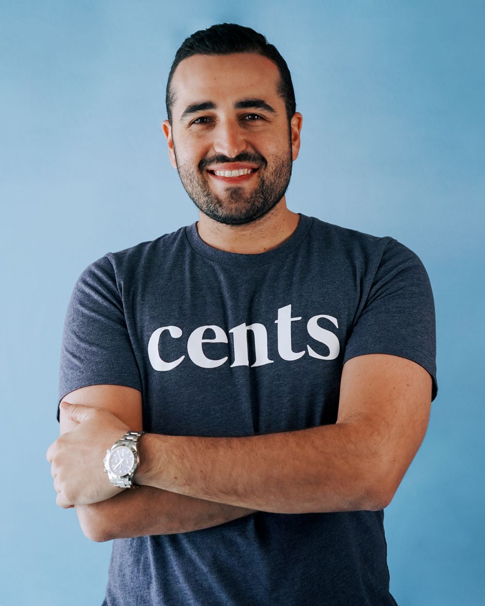 Portrait series against a blue background showing someone wearing a navy t-shirt with 'cents' text.