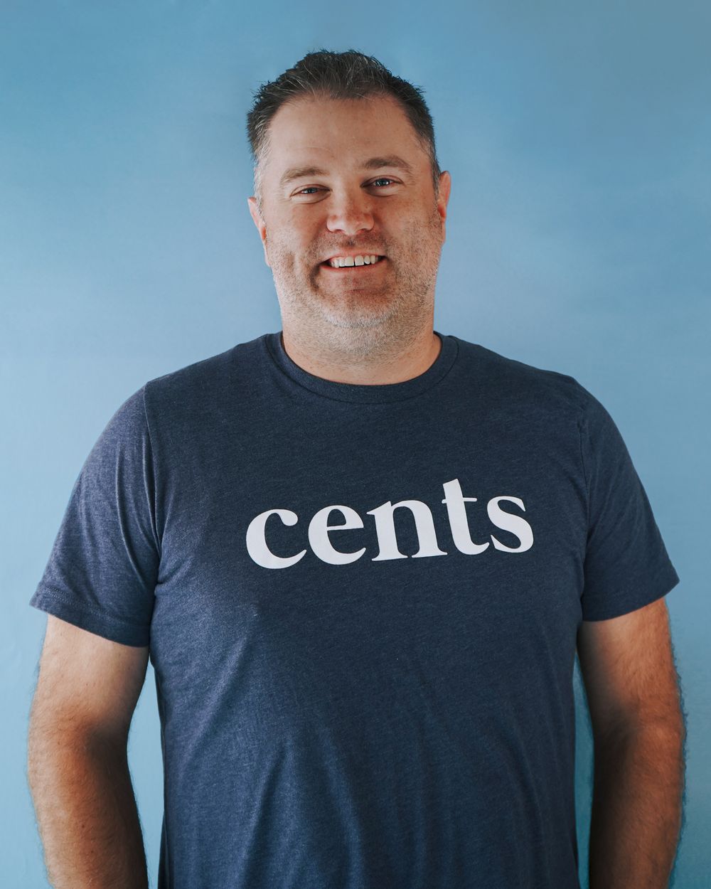 Multiple shots of someone wearing a dark t-shirt with 'cents' typography against a blue backdrop.