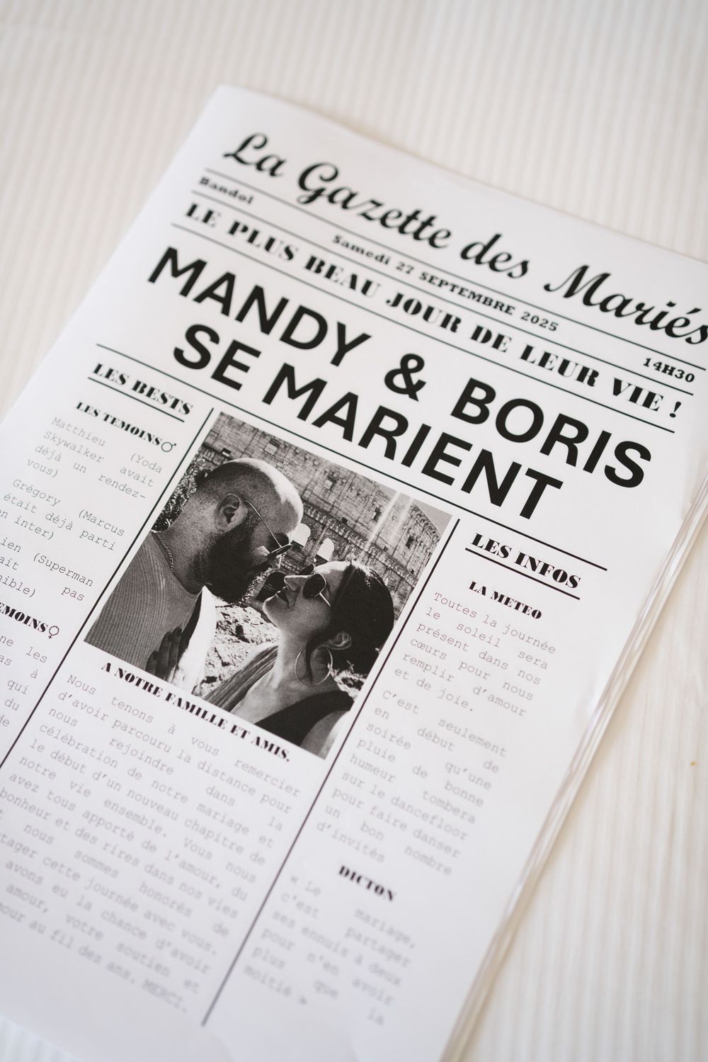 Black and white vintage newspaper pages with French text and headlines laid out on a white surface.