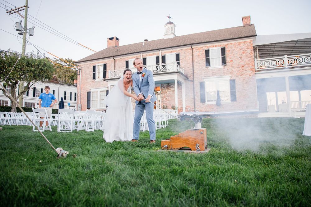 Wedding ceremony setup on a lawn with white chairs and decorative smoke creating an ethereal atmosphere.
