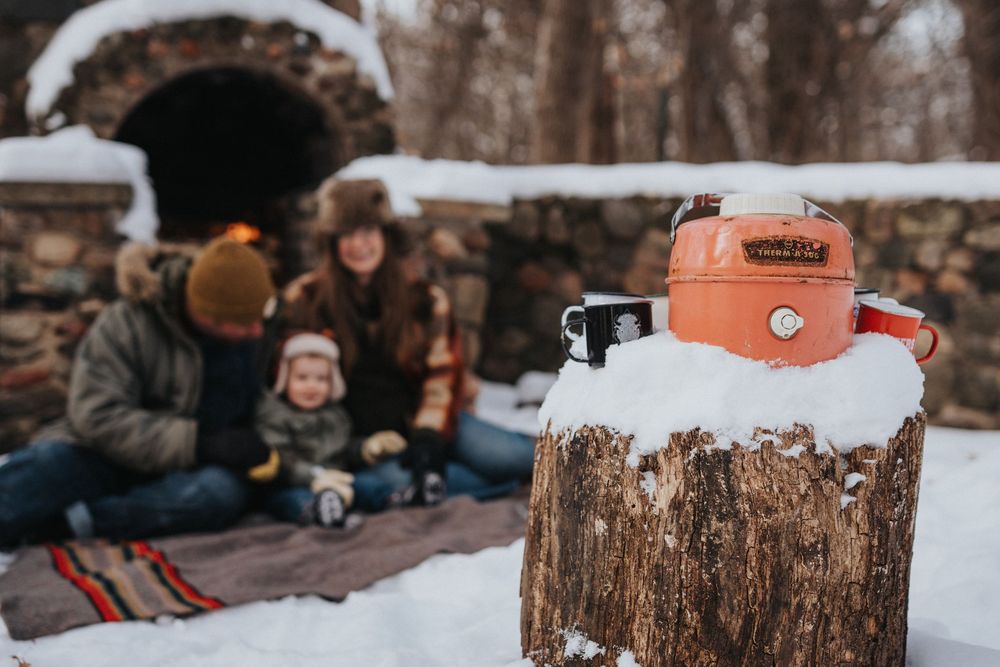 A series of winter photos showing snowy scenes with tree stumps and outdoor activities in a rustic setting.