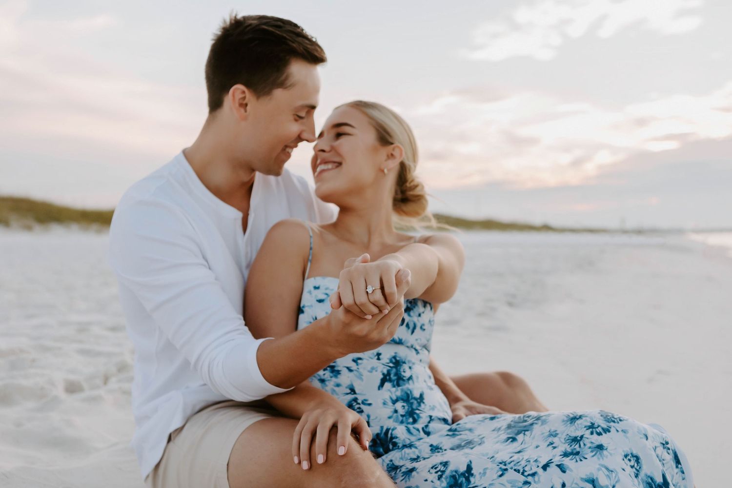 A couples photo session in Destin Florida of a man and woman getting engaged and showing off the engagement ring