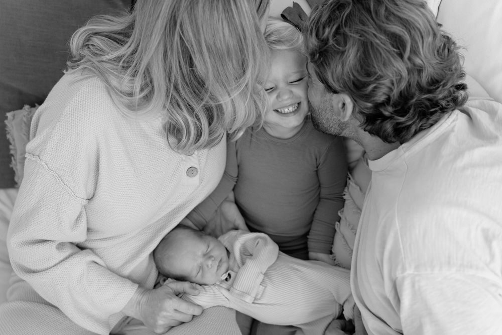 A black and white photo strip showing tender moments between a couple in romantic poses and embraces.