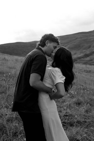 Dramatic black and white couple portraits showing intimate moments in a mountain meadow.