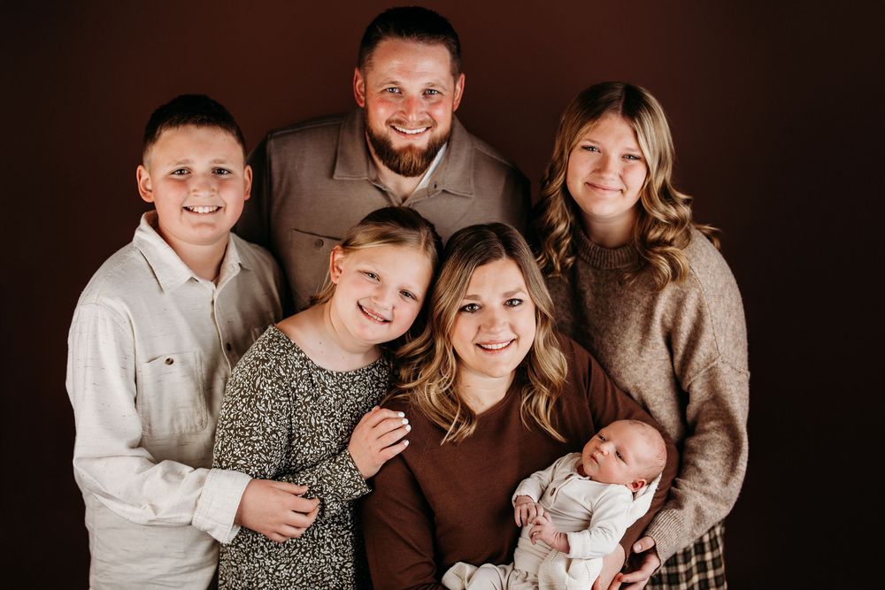 Family portrait series in warm brown tones showing group poses and interactions.