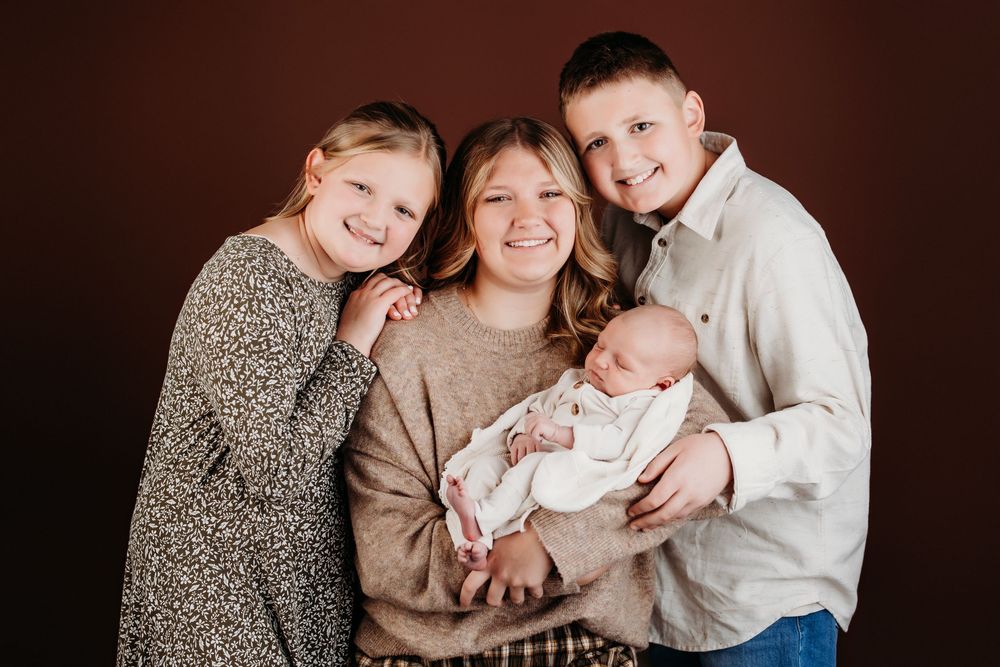 A series of warm, intimate family portrait photographs arranged in a horizontal collage against a dark background.