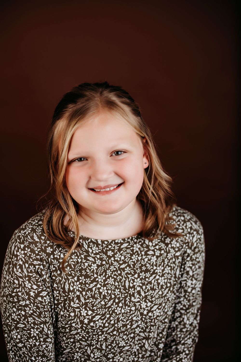 A series of four close-up portrait shots showing joyful expressions and a patterned sweater against a dark background.