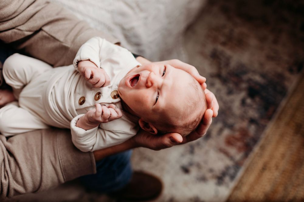 A series of intimate poses showing siblings bonding together on a dark backdrop.